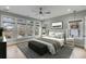 A serene bedroom featuring large windows, light gray walls, and a comfortable bed with stylish gray accents at 915 Dill Ave, Charleston, SC 29412