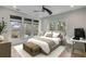 Cozy bedroom with natural light, comfortable bed, white desk and ceiling fan, ideal for relaxation and productivity at 915 Dill Ave, Charleston, SC 29412