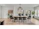 Dining room with a large table, chairs, and a decorative light fixture with lots of natural light at 915 Dill Ave, Charleston, SC 29412