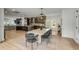 Open-concept dining room with an elegant table set and seamless view into the modern kitchen at 915 Dill Ave, Charleston, SC 29412