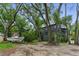 Modern house is surrounded by tall trees and a large yard with a boat parked on the side at 915 Dill Ave, Charleston, SC 29412