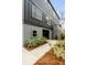Side view of the home featuring a concrete pathway, greenery, and access to the garage at 915 Dill Ave, Charleston, SC 29412