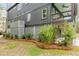 Home's siding and a covered porch with a ceiling fan, surrounded by green foliage and pine straw at 915 Dill Ave, Charleston, SC 29412