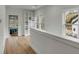 Bright hallway featuring hardwood floors, built in shelving, and natural light through the windows at 915 Dill Ave, Charleston, SC 29412