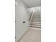 Hallway with white doors, modern hardware and a staircase leading to the upper level at 915 Dill Ave, Charleston, SC 29412