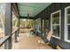 Relaxing covered porch with comfortable seating and a ceiling fan at 915 Dill Ave, Charleston, SC 29412