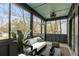 Inviting screened porch with comfortable seating and views of the surrounding trees at 915 Dill Ave, Charleston, SC 29412