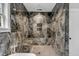 Luxurious walk-in shower with dark marble tiles, a rainfall showerhead, and a built-in bench at 915 Dill Ave, Charleston, SC 29412