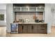 Stylish wet bar featuring wine storage, beverage cooler, and elegant backsplash at 915 Dill Ave, Charleston, SC 29412