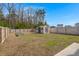 Spacious backyard with a shed, wooden fence, and ample green space at 9747 Roseberry Street, Ladson, SC 29456