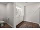 Modern bathroom with double vanity, wood-look floors, and bright lighting at 9747 Roseberry Street, Ladson, SC 29456
