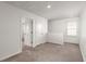 Bright bedroom with neutral carpet, ample natural light, and white trim at 9747 Roseberry Street, Ladson, SC 29456