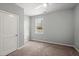 Bedroom with neutral carpet, and a window overlooking backyard at 9747 Roseberry Street, Ladson, SC 29456