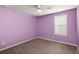 Bedroom featuring lilac walls, neutral carpet, and a window with natural light at 9747 Roseberry Street, Ladson, SC 29456