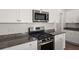 Close up shot of the kitchen gas range and stone countertops at 9747 Roseberry Street, Ladson, SC 29456