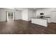 Open-concept living area with hardwood floors, a kitchen island, and access to backyard at 9747 Roseberry Street, Ladson, SC 29456