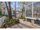 Landscaped backyard featuring a paved walkway, mature trees, and sunroom at 1013 Barfield St, Charleston, SC 29492