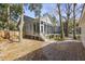 Spacious backyard featuring brick pavers, mature trees, and partial fencing for privacy at 1013 Barfield St, Charleston, SC 29492