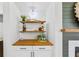 Home bar area with wood countertop, white cabinets and wood shelves at 1013 Barfield St, Charleston, SC 29492