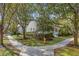 Street view of a charming home with mature trees, landscaping, and sidewalks in a desirable neighborhood at 1013 Barfield St, Charleston, SC 29492