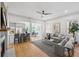 Bright and spacious living room with hardwood floors, fireplace, and open layout to the kitchen and dining area at 1013 Barfield St, Charleston, SC 29492