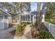 Cozy sunroom extension with screen windows and white frames nestled in a naturally landscaped garden at 1013 Barfield St, Charleston, SC 29492