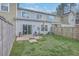 Backyard featuring a patio, lawn, and wooden fence under a blue sky with scattered clouds at 106 Kirkland St, Goose Creek, SC 29445