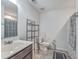 Bathroom with a single vanity, toilet, shelving unit, and a shower with grey and white curtain at 106 Kirkland St, Goose Creek, SC 29445