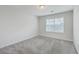 Bright bedroom featuring neutral carpet, white walls, and a window bringing in natural light at 106 Kirkland St, Goose Creek, SC 29445