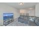 Comfortable living area with a large gray sectional, scenic TV display, and a cozy atmosphere at 106 Kirkland St, Goose Creek, SC 29445