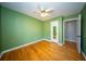 Green bedroom showcasing hardwood floors, closet, and doorway at 106 Rachel St, Goose Creek, SC 29445