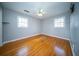 Empty bedroom featuring hardwood floors, a ceiling fan and two windows for ample lighting at 106 Rachel St, Goose Creek, SC 29445