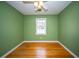 Cozy bedroom with hardwood floors, ceiling fan, and a bright window at 106 Rachel St, Goose Creek, SC 29445