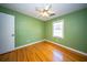 Bedroom features hardwood floors, ceiling fan, and a window for natural light at 106 Rachel St, Goose Creek, SC 29445