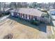 Charming brick home featuring red shutters, well-maintained landscaping, and a spacious front yard at 106 Rachel St, Goose Creek, SC 29445