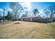 Charming brick home featuring red shutters, well-maintained landscaping, and a spacious front yard at 106 Rachel St, Goose Creek, SC 29445