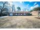 Charming brick home featuring red shutters, well-maintained landscaping, and an attached garage at 106 Rachel St, Goose Creek, SC 29445