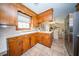 Functional kitchen with wood cabinets, updated appliances, and a view into the dining area at 106 Rachel St, Goose Creek, SC 29445