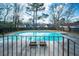 Backyard pool surrounded by a fence and mature trees at 106 Rachel St, Goose Creek, SC 29445