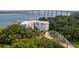 Aerial view of condo building with water access, surrounded by lush trees and plants at 108 Fairbanks Oak Aly # 201, Charleston, SC 29492
