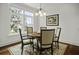 Cozy dining nook with a round wooden table, upholstered seating, and a window with a water view at 108 Fairbanks Oak Aly # 201, Charleston, SC 29492