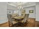 Elegant dining room with a coffered ceiling, chandelier, decorative chairs, and hardwood floors at 108 Fairbanks Oak Aly # 201, Charleston, SC 29492