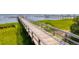 Long wooden dock stretches out over the water, offering scenic views of the surrounding marsh at 108 Fairbanks Oak Aly # 201, Charleston, SC 29492