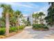 Exterior driveway with lush palm trees and landscaping leading to the beautiful condo building at 108 Fairbanks Oak Aly # 201, Charleston, SC 29492