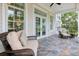 Relaxing covered patio featuring wicker furniture and tiled flooring, perfect for enjoying the outdoors at 108 Fairbanks Oak Aly # 201, Charleston, SC 29492