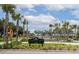 View of Waterfront Park entrance sign framed by palm trees and manicured landscaping at 108 Fairbanks Oak Aly # 201, Charleston, SC 29492