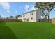 View of the home from the backyard with well-maintained lawn and privacy fence at 1105 Mossy Rock Dr, Summerville, SC 29485