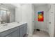 Bright bathroom with double vanity, gray cabinets, and tiled shower with glass door at 1105 Mossy Rock Dr, Summerville, SC 29485
