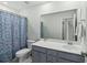 Bathroom with blue patterned shower curtain, toilet, and modern vanity with a large mirror at 1105 Mossy Rock Dr, Summerville, SC 29485