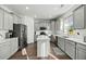 Modern kitchen featuring gray cabinets, quartz countertops, stainless steel appliances, and a center island at 1105 Mossy Rock Dr, Summerville, SC 29485